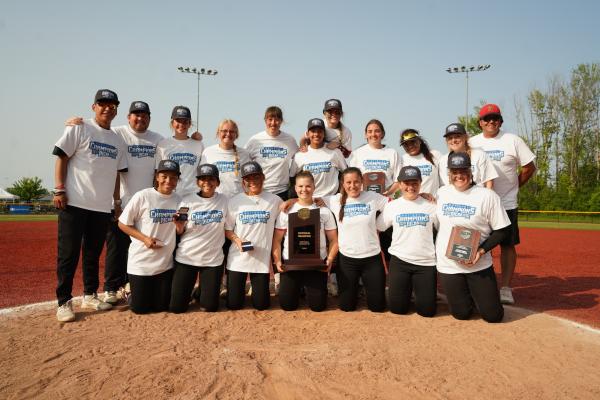 photo of softball team with national championship plaque
