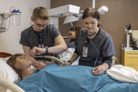 Nursing students working on a simulation