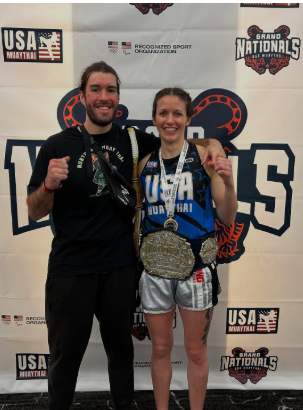 Theresa Branco with trophy next to her husband.